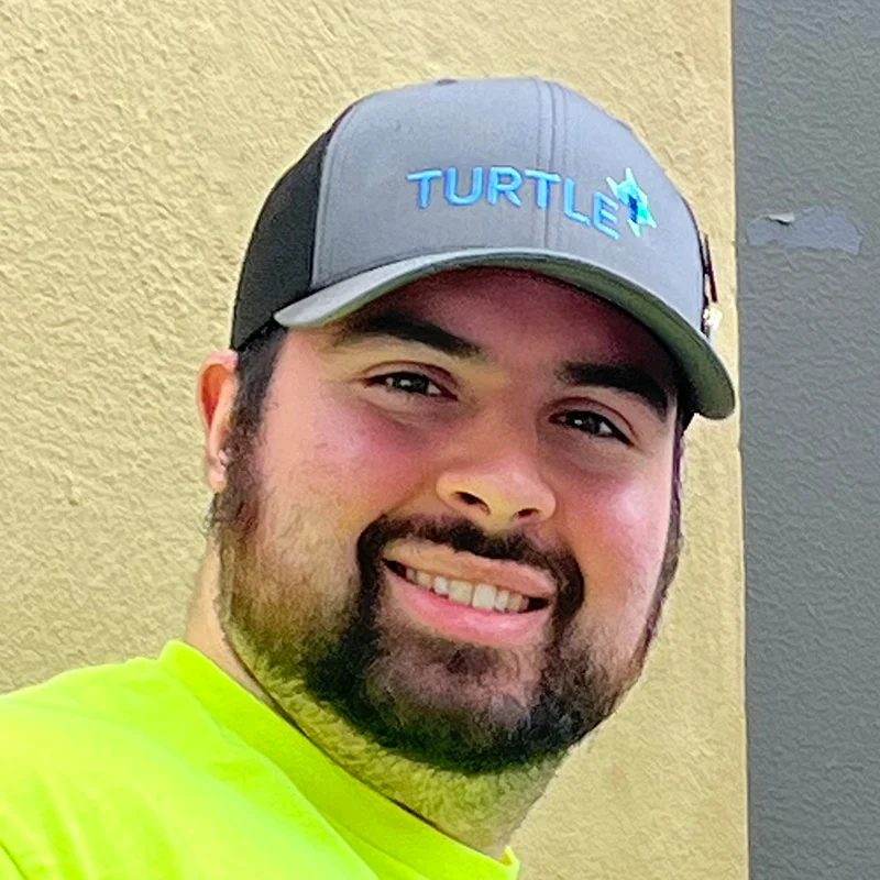 Turtle company Employee wearing hat and neon top