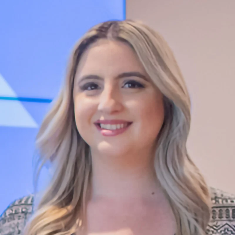 Close up headshot of Turtle Company employee at event with blue backdrop
