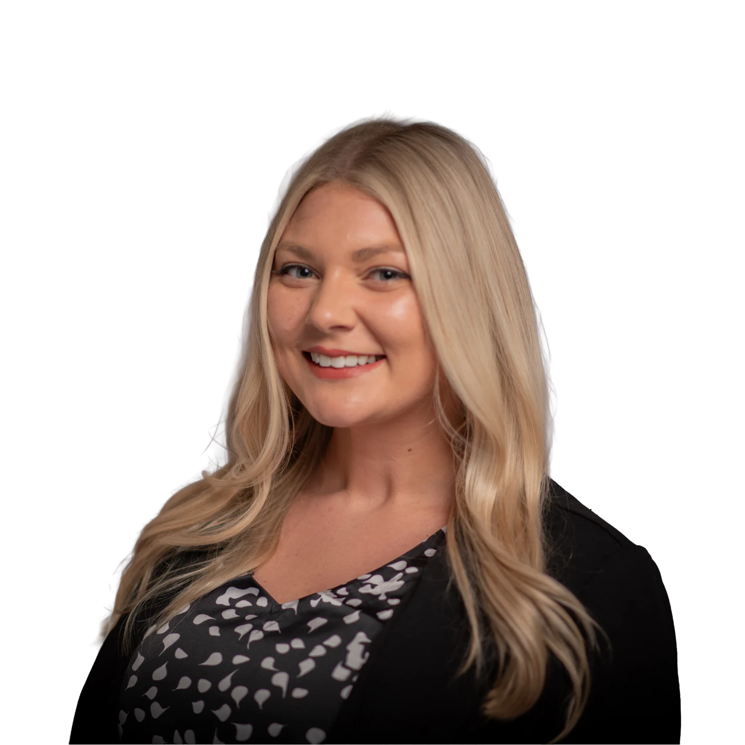 Professional headshot of a smiling woman wearing a black blazer over a black-and-white patterned blouse.