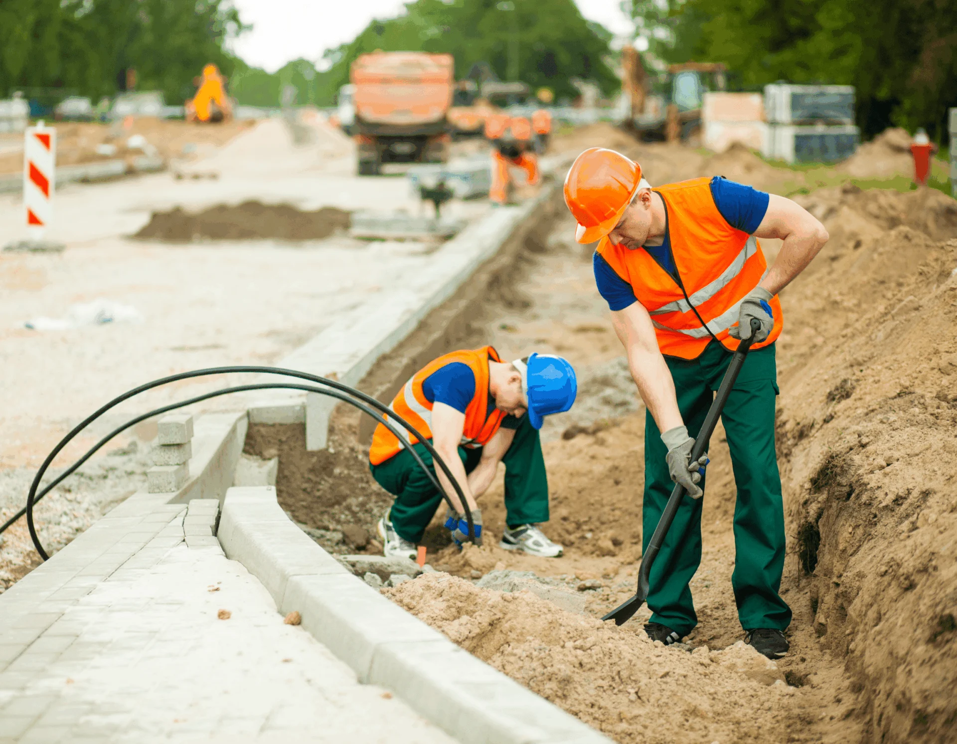 Construction workers digging by road
