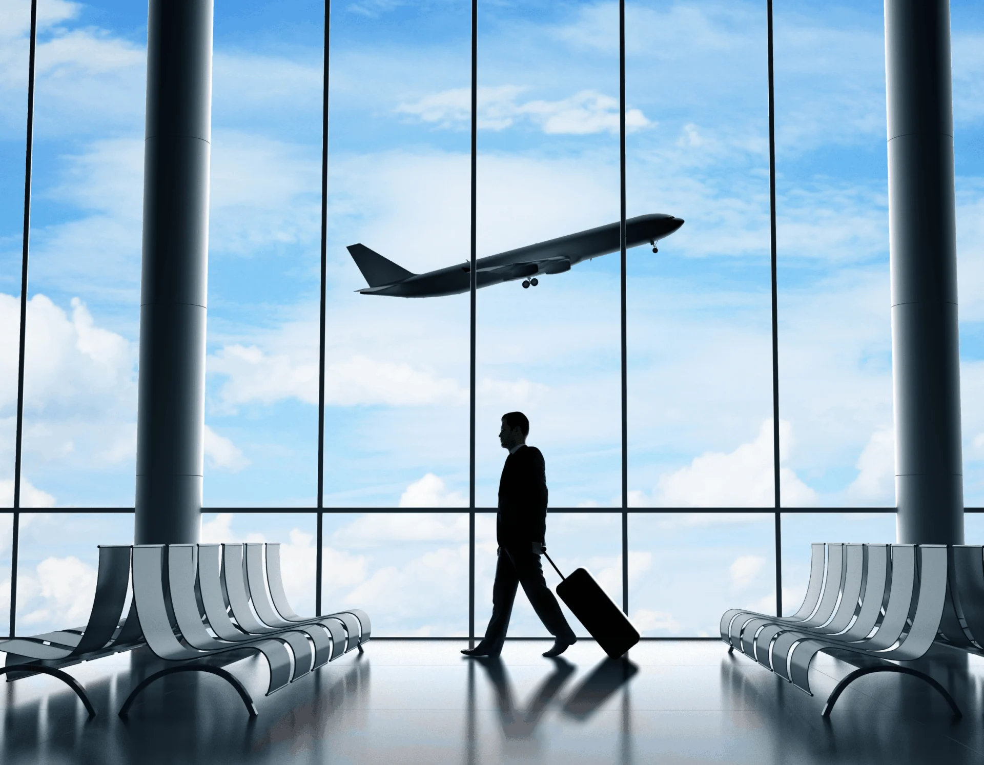 Traveler walking in airport terminal with luggage silhouette 
