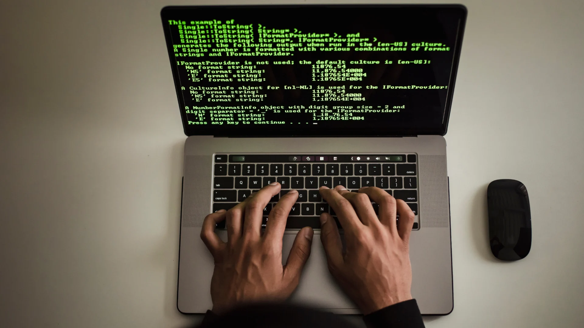 Hands typing on laptop